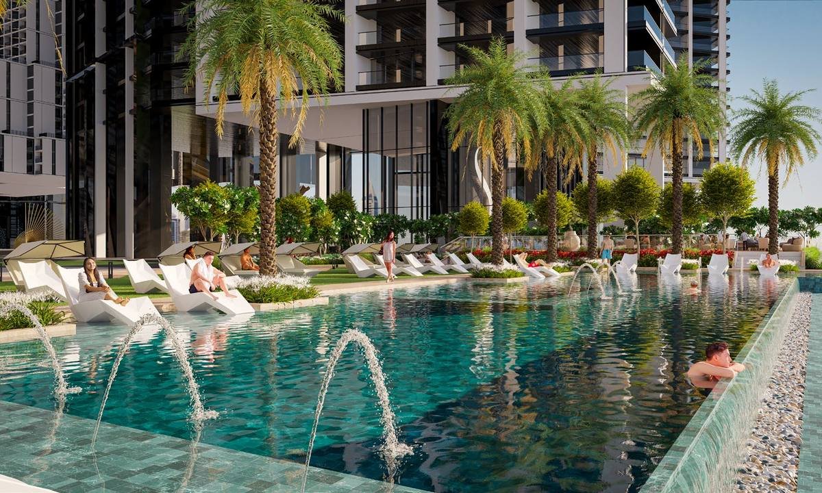 Podium-level swimming pool at Sobha Central with palm trees and loungers
